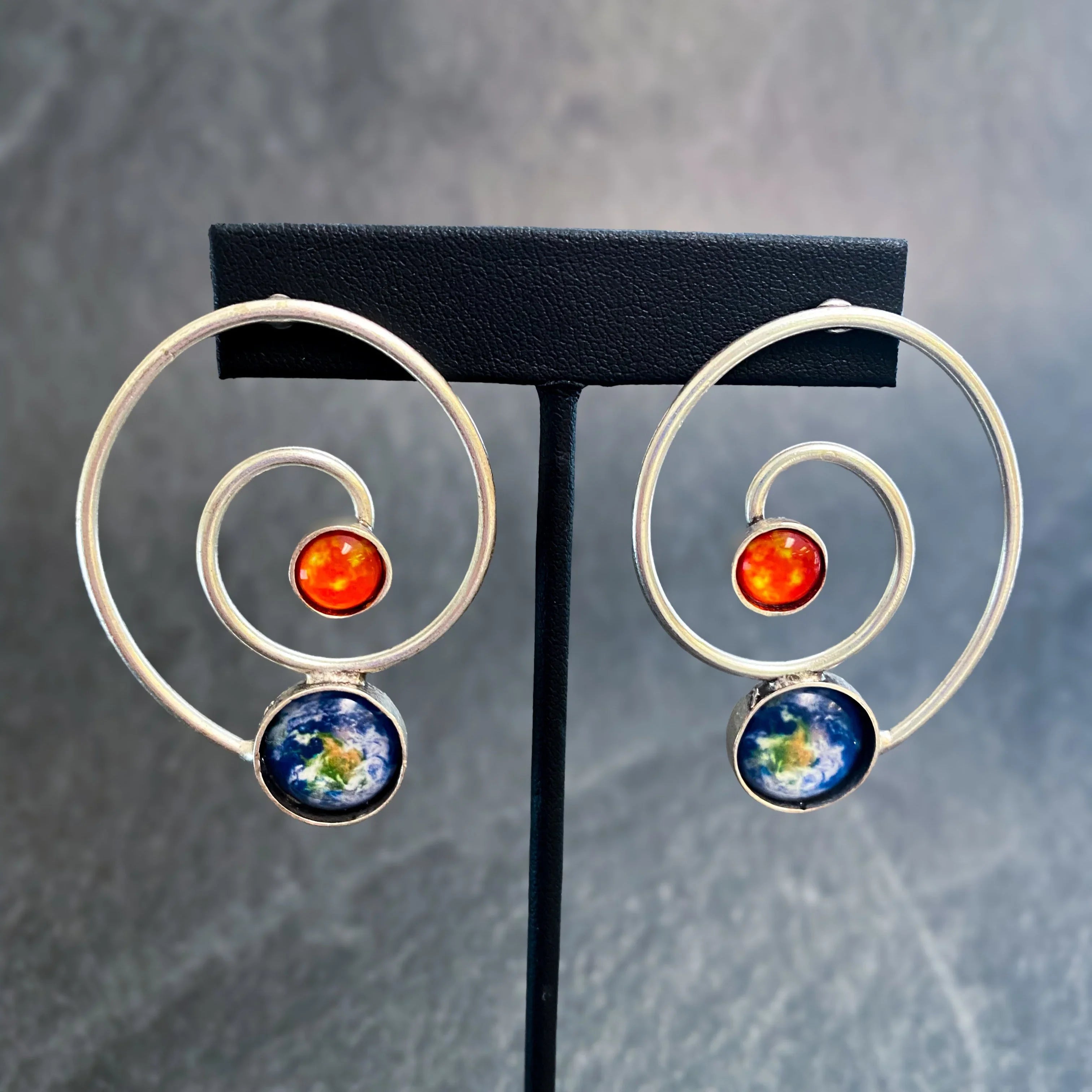 Spiral silver earrings with sun and earth designs, cosmic jewelry at Qu!rk Boutique