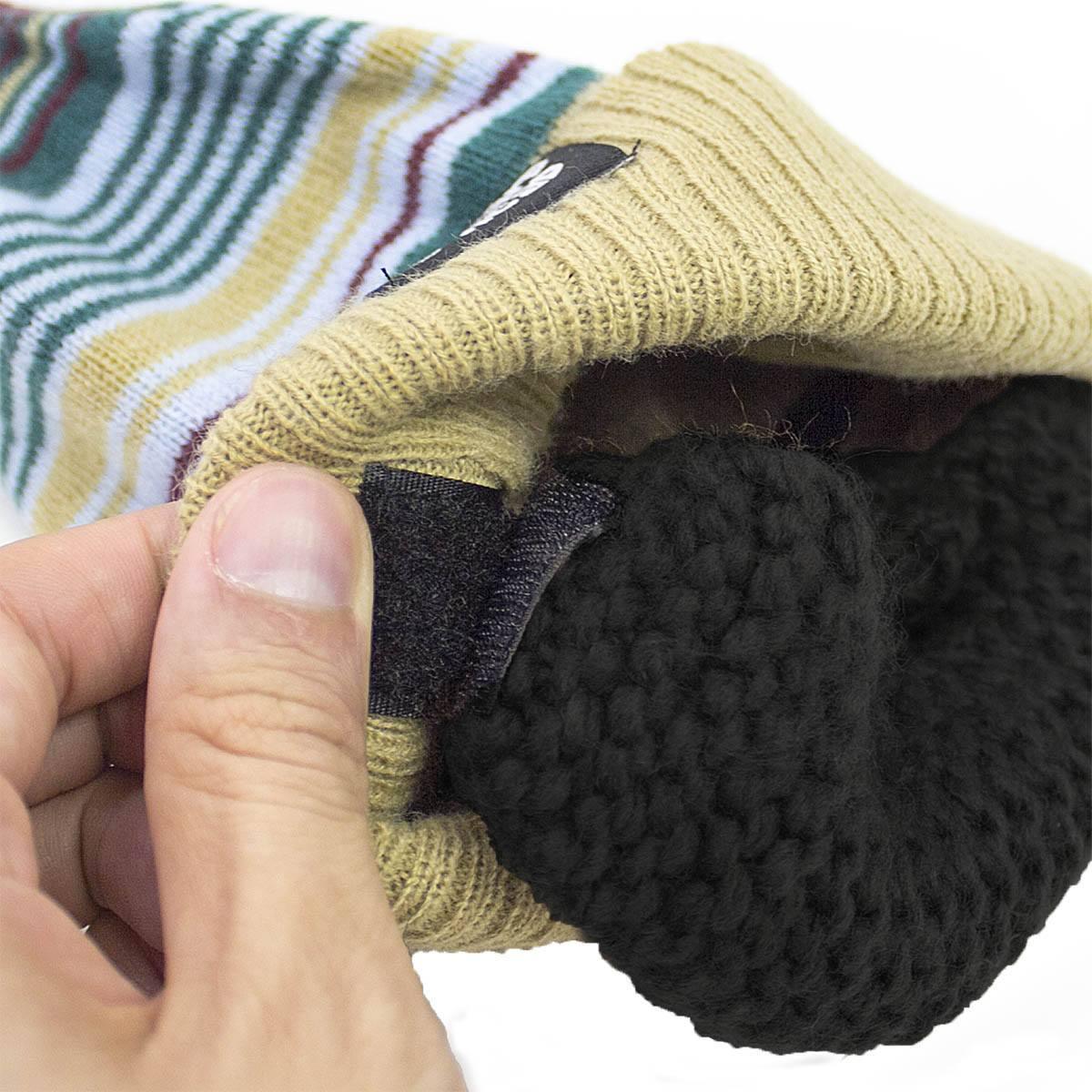 Hand holding striped knit beanie hat with removable black knit ear warmer attachment