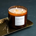 Lavender cedar soy candle with three flames in amber glass, on a gold tray at Qu!rk Boutique