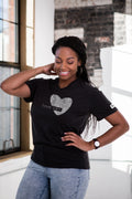 Smiling woman in charcoal unisex V-neck t-shirt with heart and 'love can.' text by Qu!rk Boutique