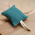 Teal Lagoon Cedar Sachet by Slow North on wood surface, sustainable gift at Qu!rk Boutique