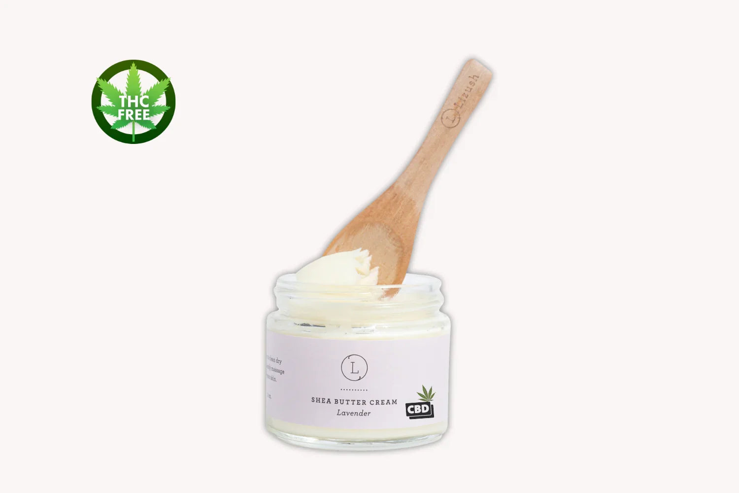 Lavender CBD shea butter cream jar with wooden spatula and THC free green leaf icon