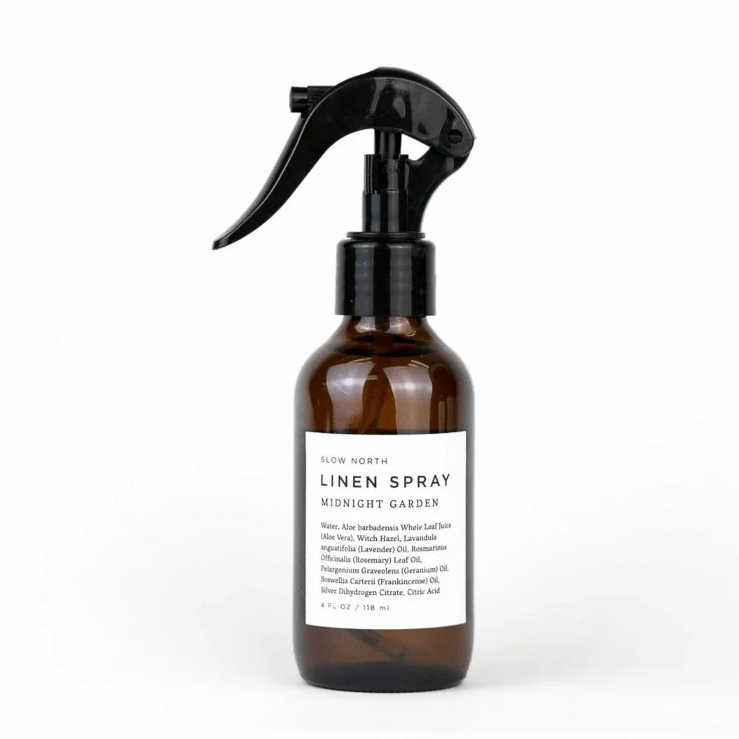 Slow North Midnight Garden linen spray in amber glass bottle with black spray top