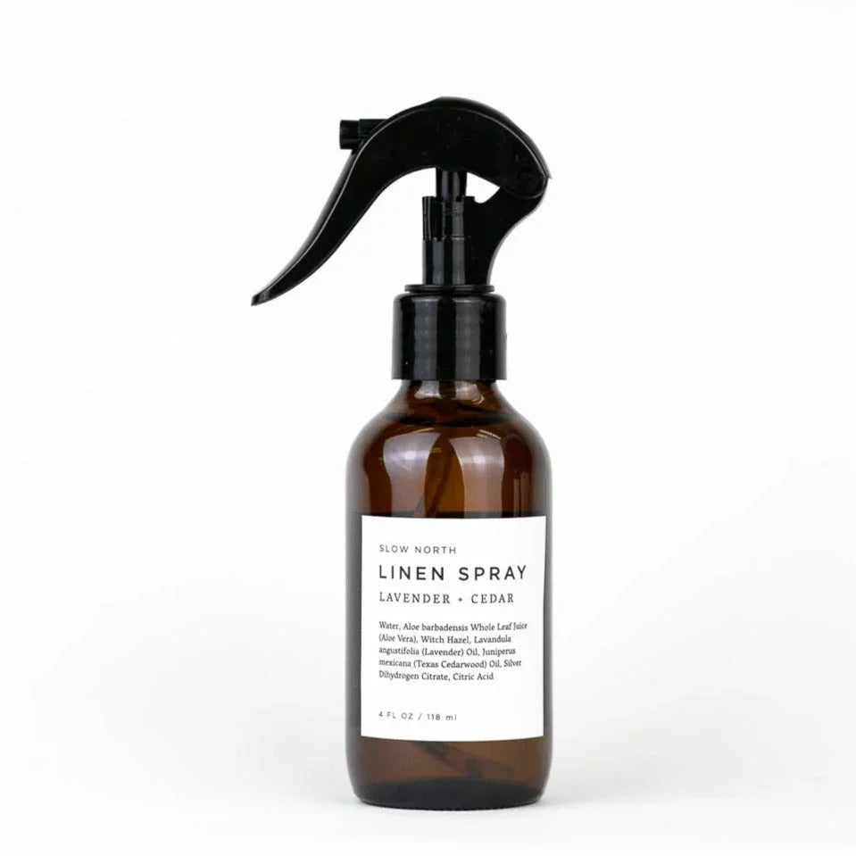 Slow North linen spray in amber bottle with black spray top, labeled lavender and cedar.