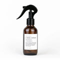 Slow North linen spray bottle with grapefruit and spearmint scent in amber glass with black trigger
