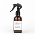 Slow North linen spray in amber bottle with black trigger, rosemary and lemon scent