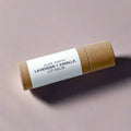 Slow North Lavender and Vanilla scented lip balm in eco-friendly brown tube on soft purple background
