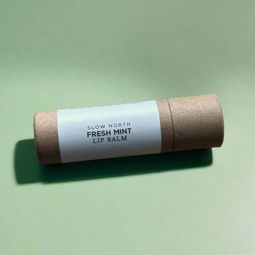 Slow North Fresh Mint lip balm in eco-friendly tube on a light green background