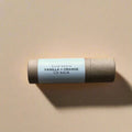 Slow North Vanilla Orange lip balm in eco-friendly tube on neutral background at Qu!rk Boutique