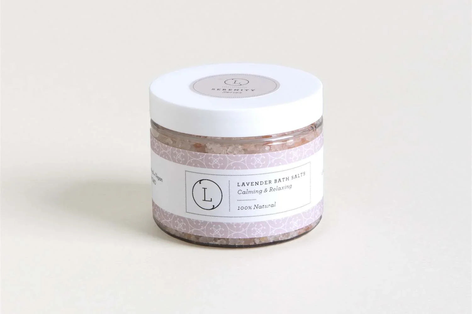 Jar of lavender bath salts with lavender-themed label on light background