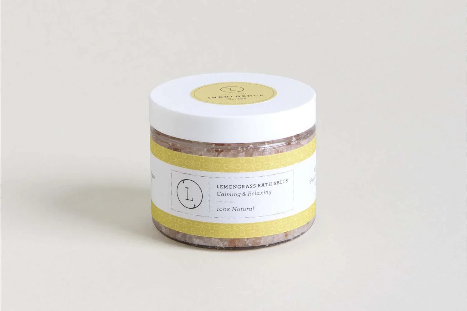 Jar of lemongrass bath salts with white lid and yellow label, calming and relaxing natural product