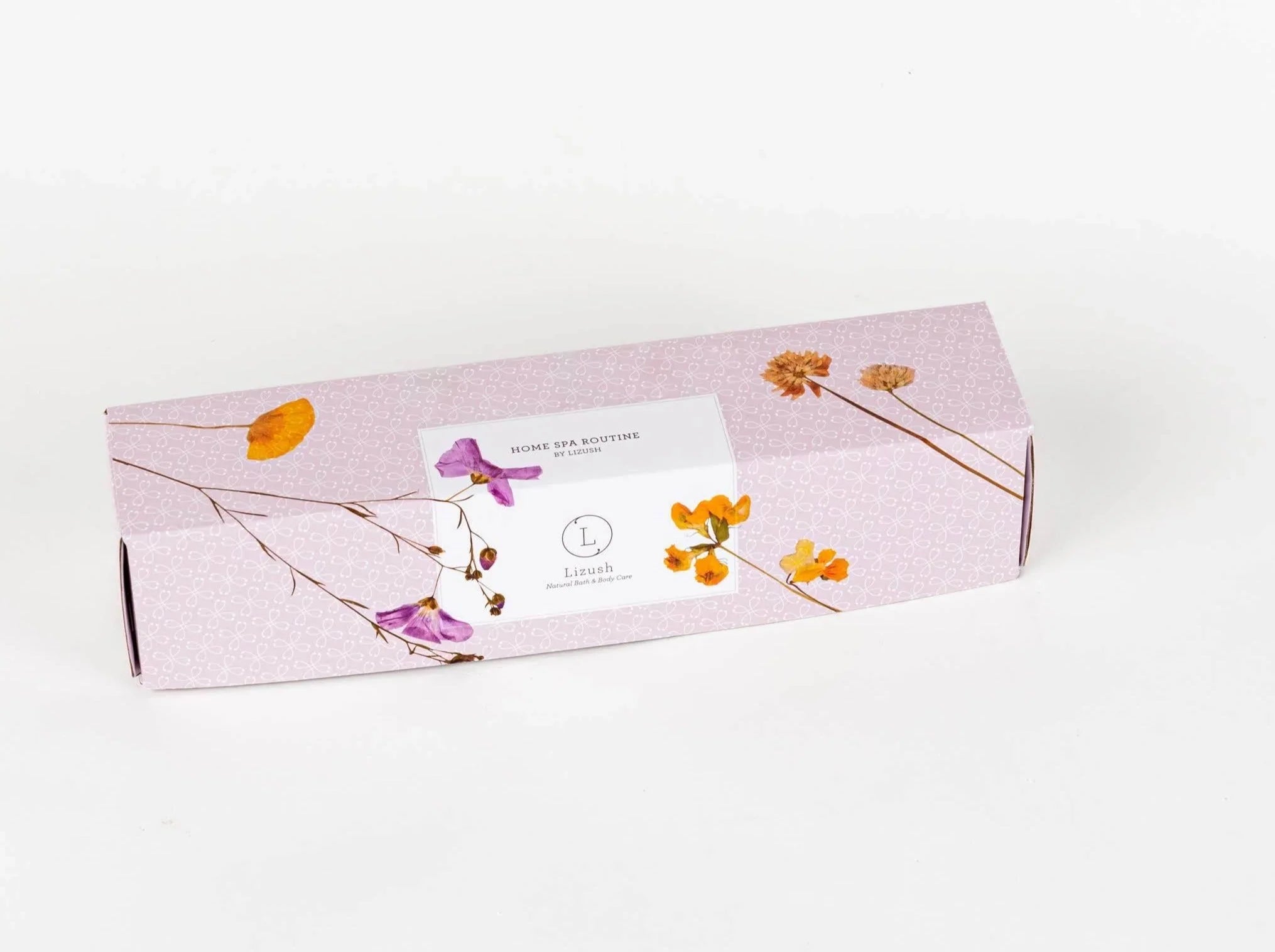 Pink rectangular box with dried orange and purple flowers, labeled Home Spa Routine by Lizush