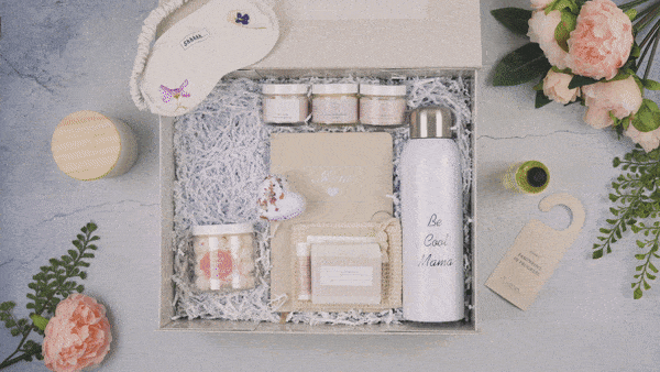 Luxury Mother's Day gift box with skincare jars, water bottle, eye mask, and flowers