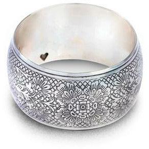 Wide silver bangle with floral engraving, featuring a small heart cutout, from Qu!rk Boutique