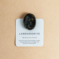 Polished labradorite meditation stone on card with calming and intuition-boosting properties