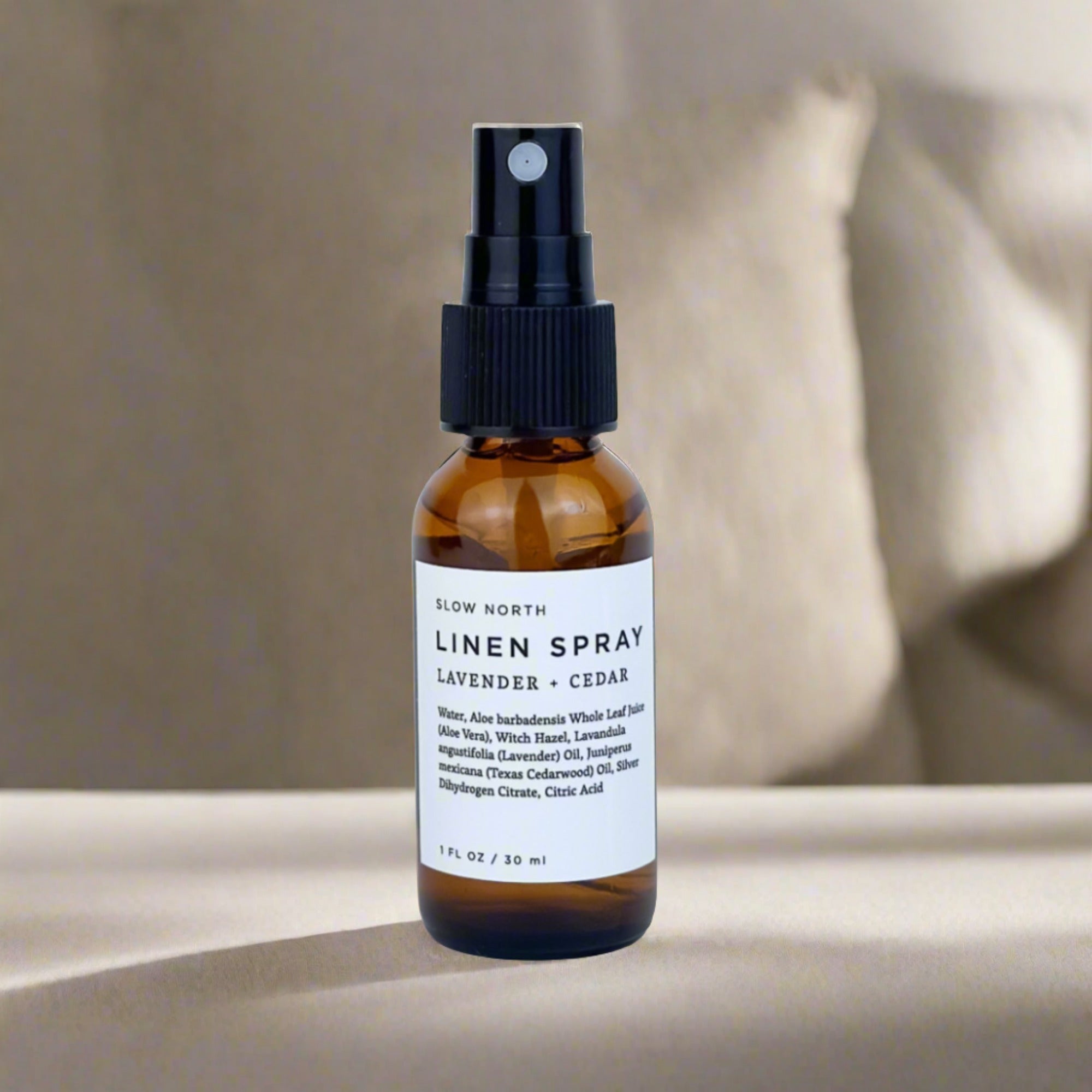 Slow North linen spray bottle with lavender and cedar scent on neutral background