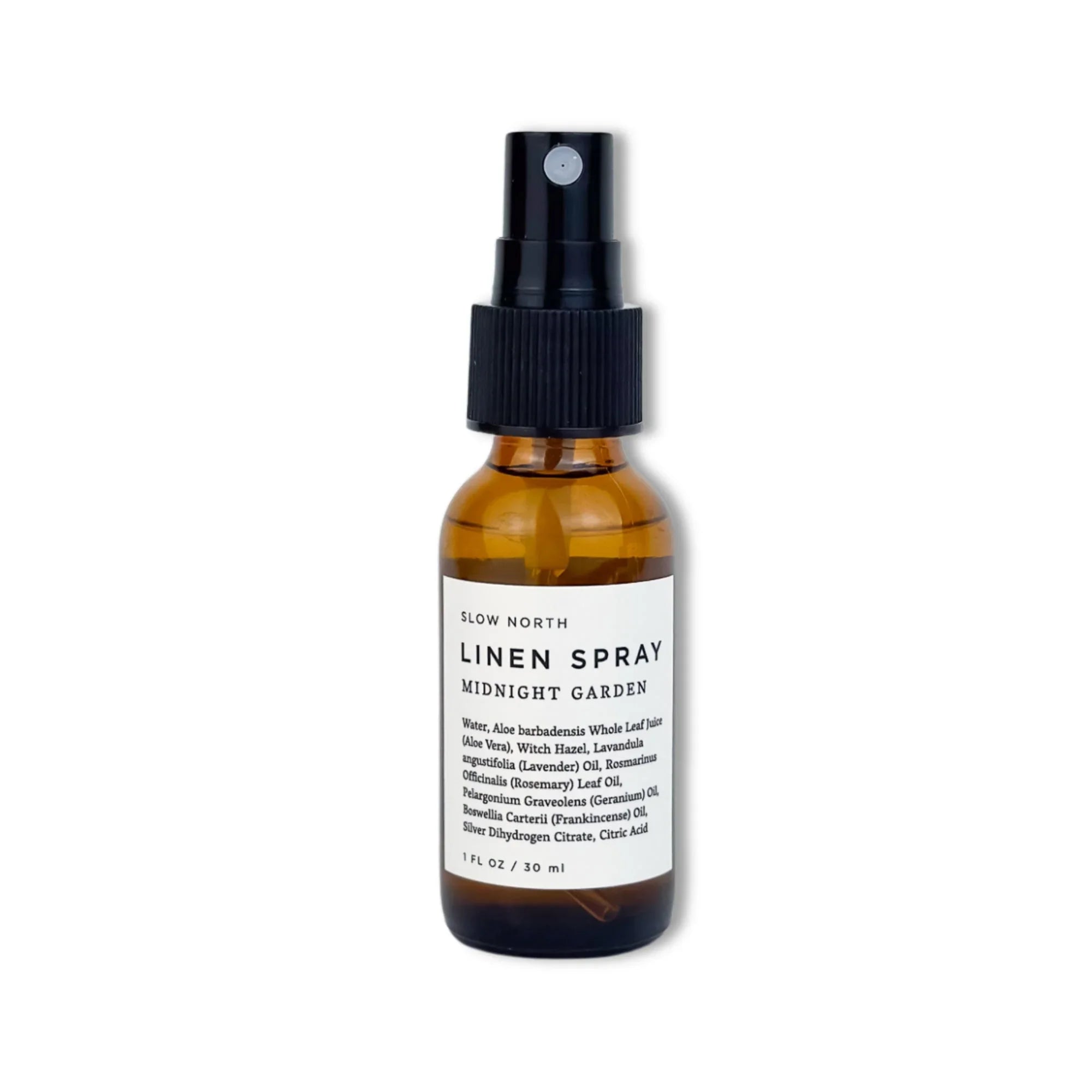 Amber glass bottle of Slow North Midnight Garden linen spray with black spray top