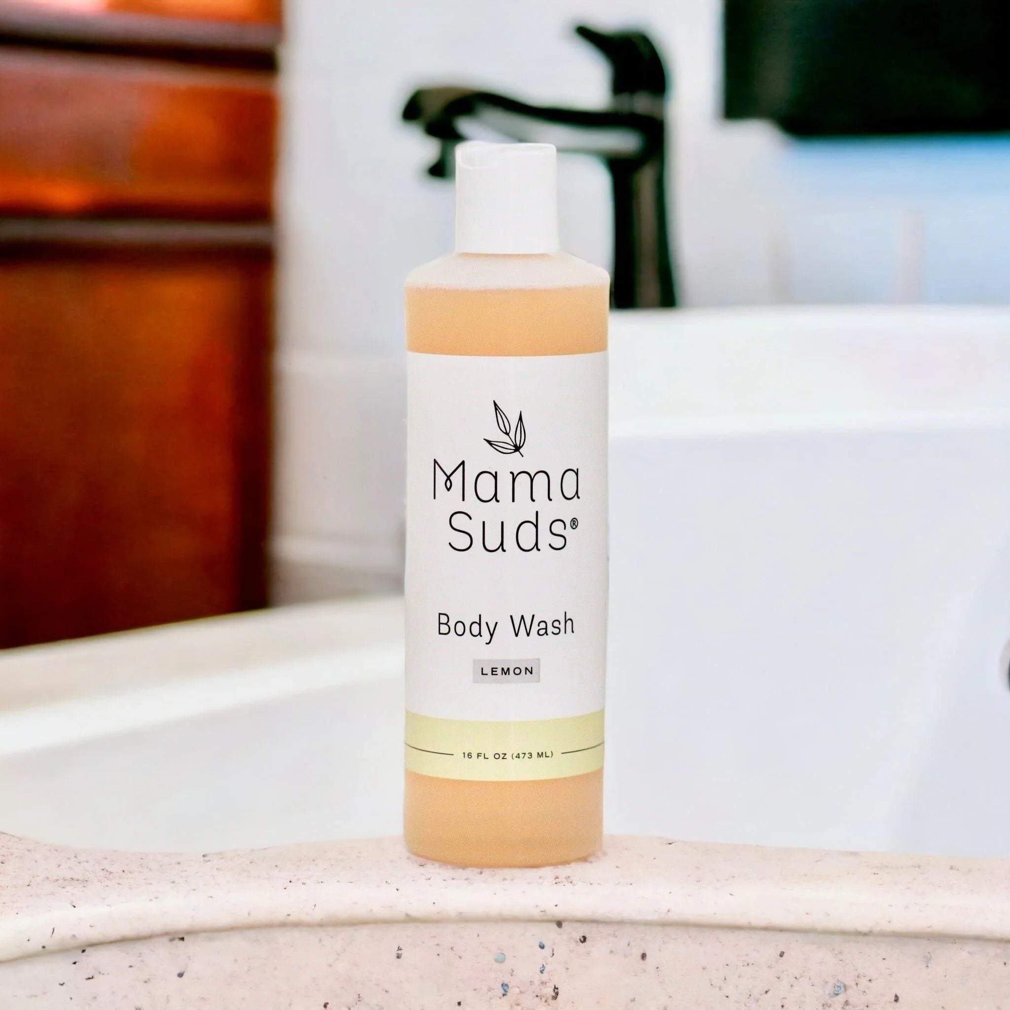 MamaSuds Lemon Body Wash bottle on a bath edge, eco-friendly skincare at Qu!rk Boutique