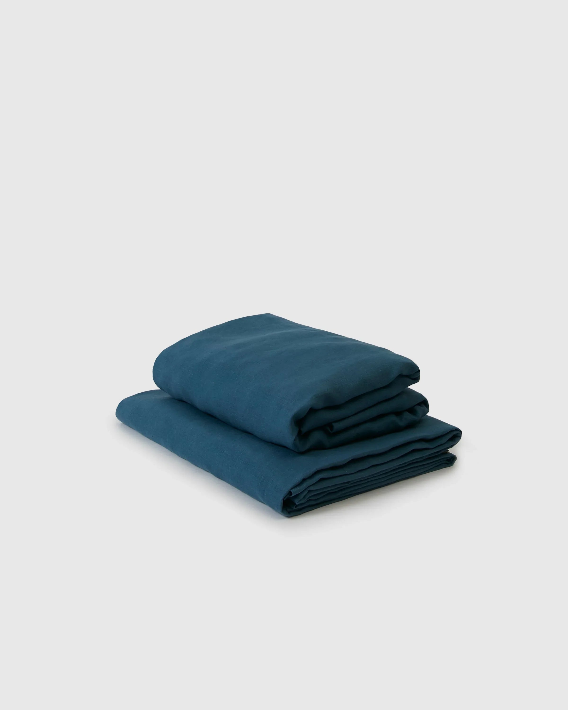 Adriatic blue linen flat and fitted sheets folded, Qu!rk Boutique eco-friendly bedding