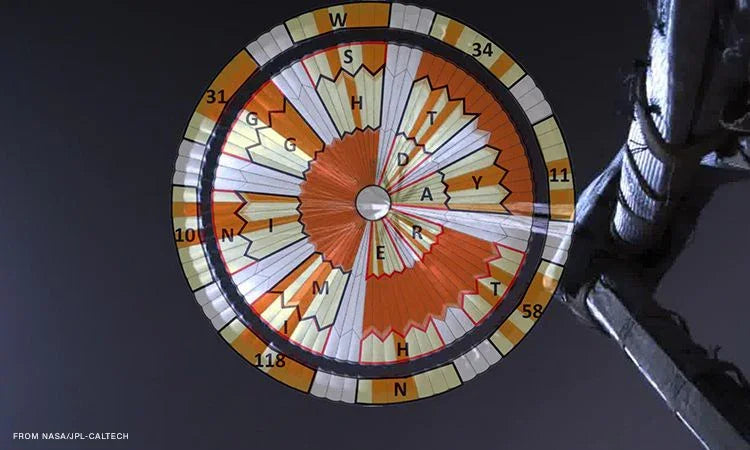 Close-up of Mars helicopter Ingenuity's orange and white rotor blade viewed from below in space
