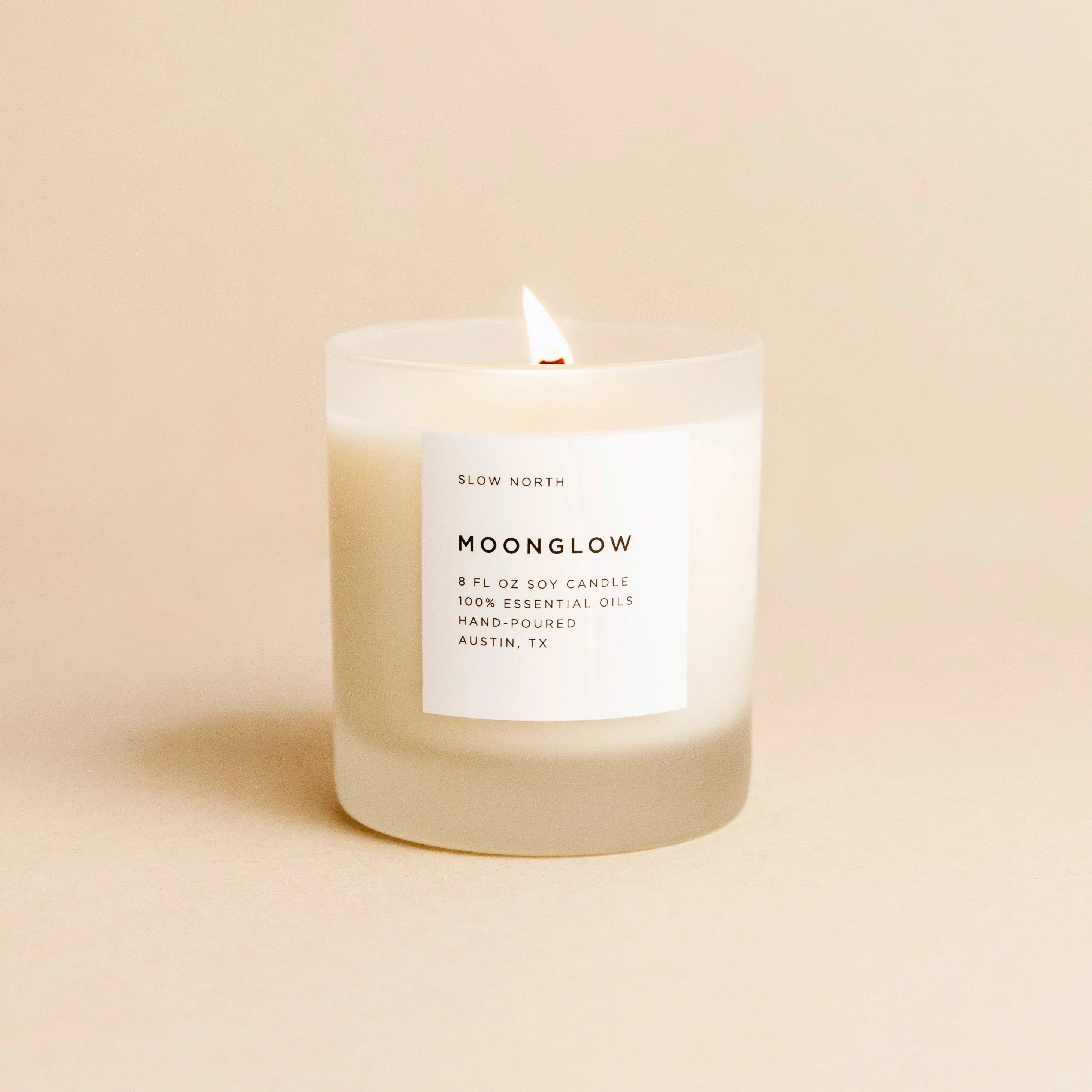 Lit Moonglow soy candle in frosted glass with essential oils, hand-poured in Austin, TX