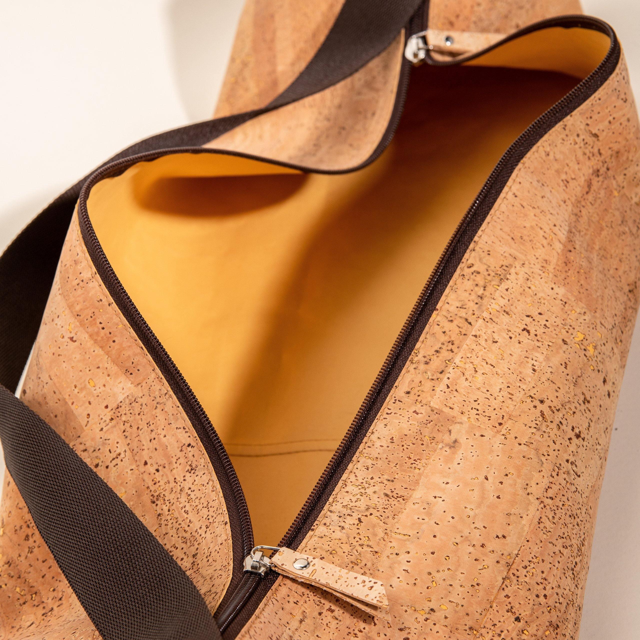 Sustainable cork duffel bag with black strap and gold interior from Qu!rk Boutique