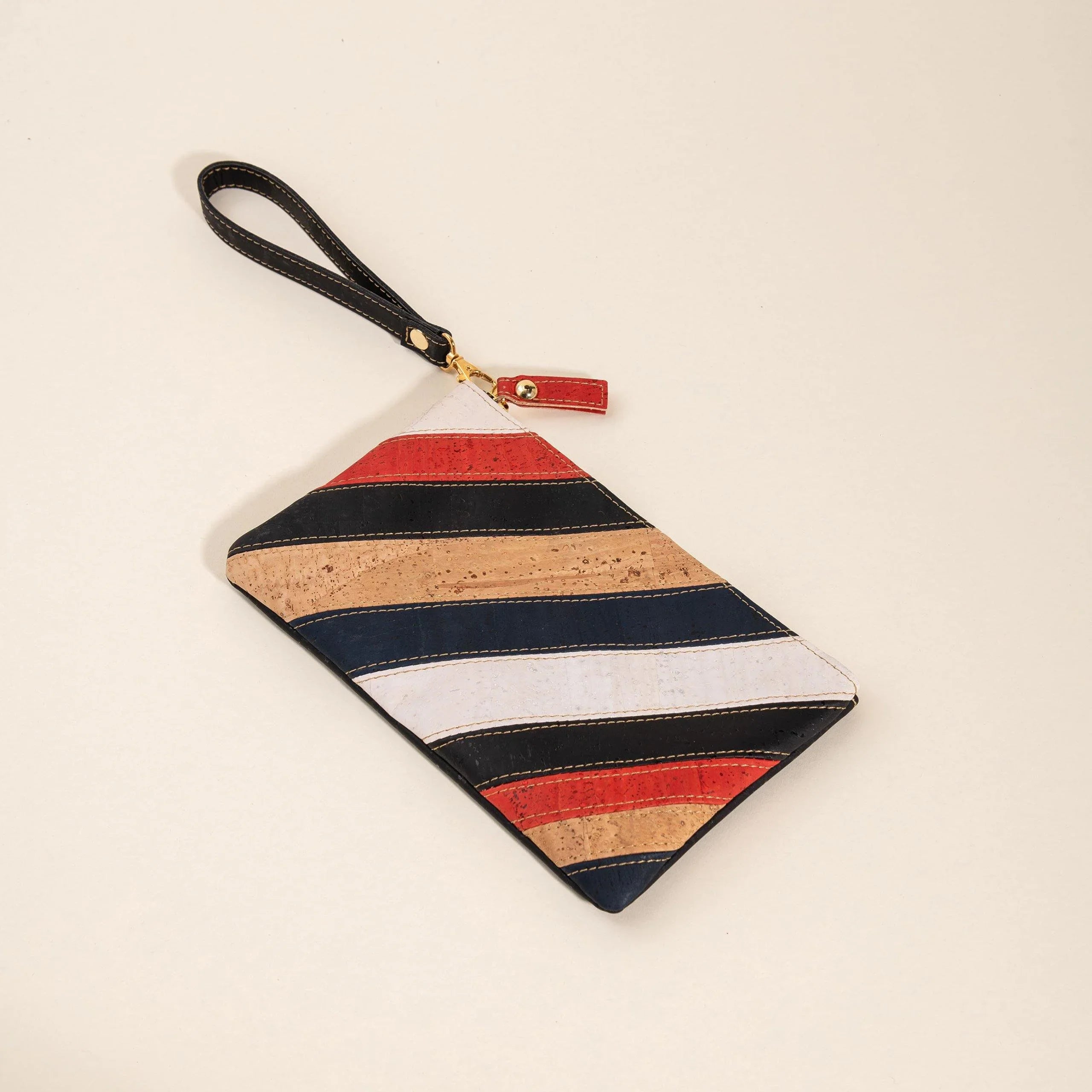 Striped cork wristlet pouch with black, red, white, and tan cosmic-inspired design