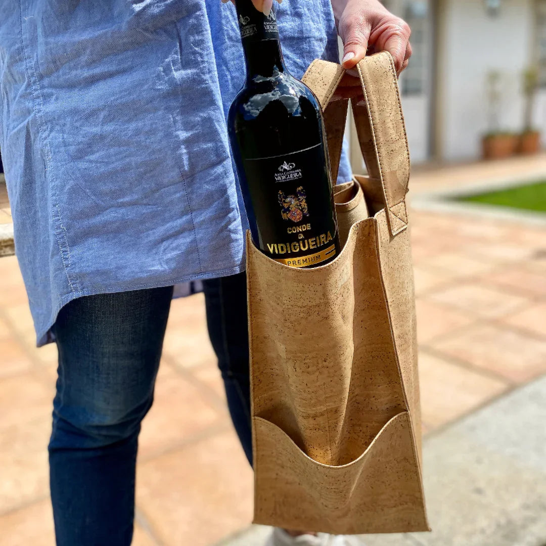 Person holding a cork wine tote bag with a bottle, eco-friendly gift at Qu!rk Boutique
