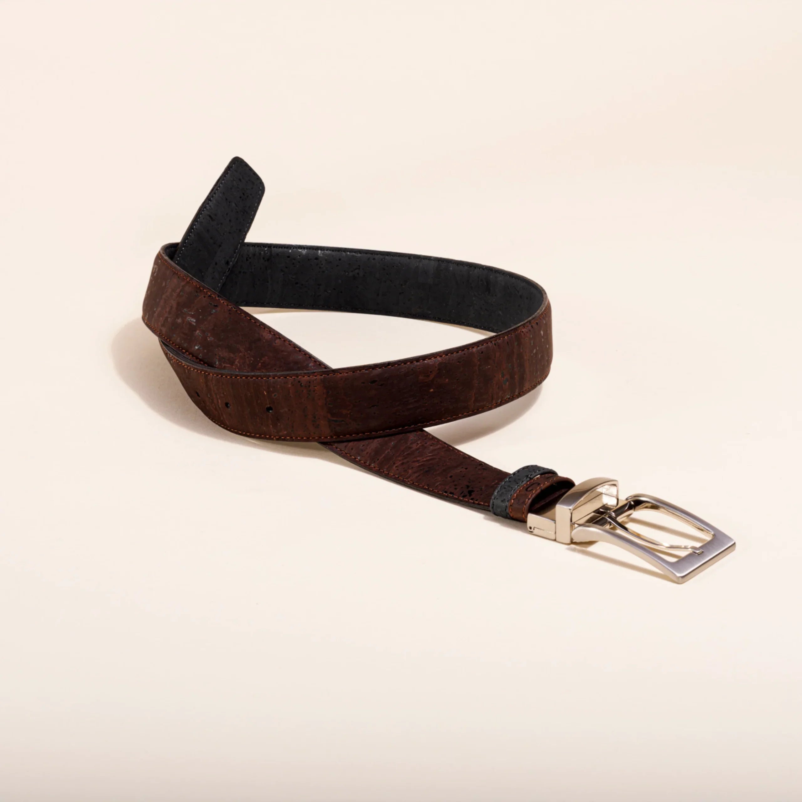 Brown cork leather belt with silver buckle on neutral background, Qu!rk Boutique accessory