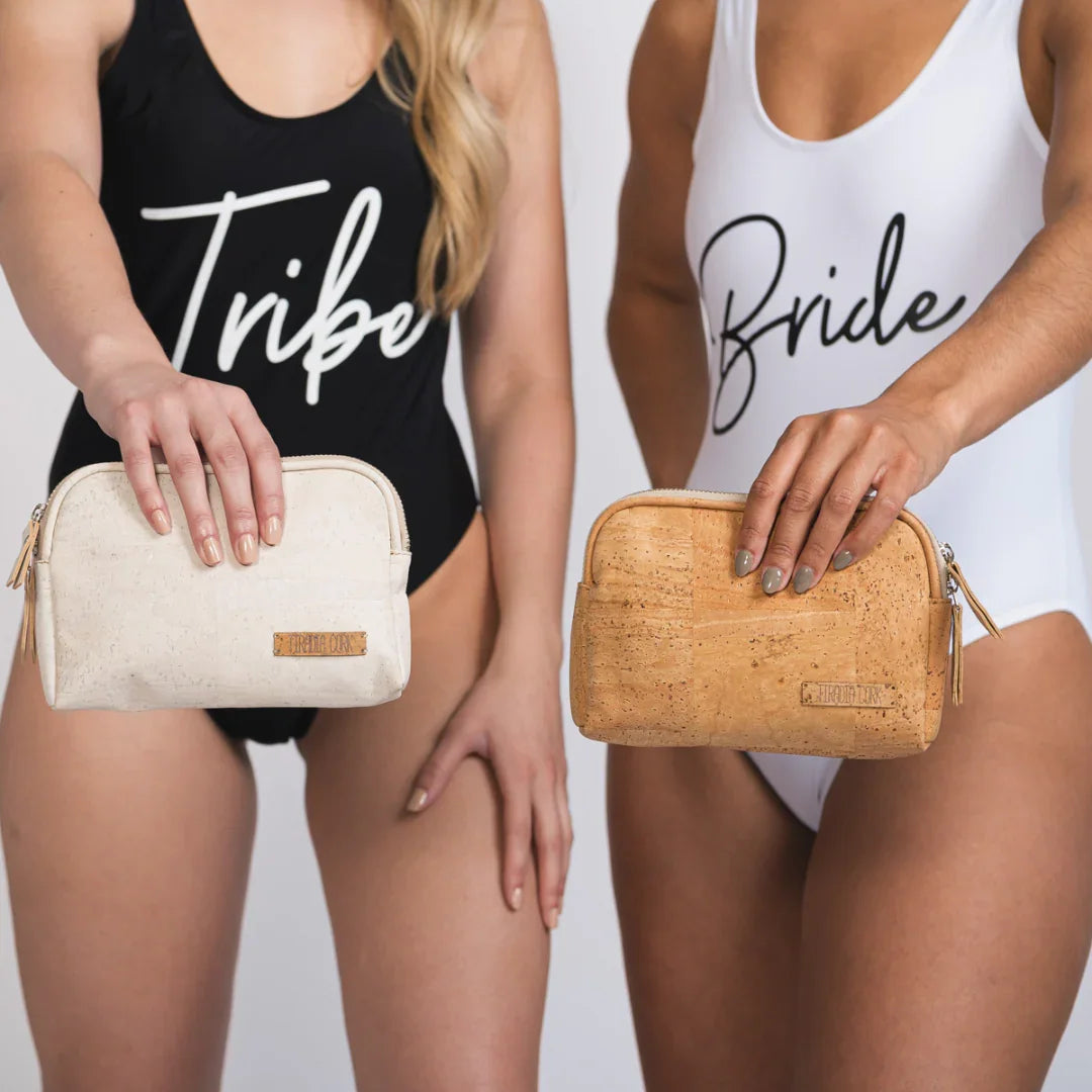 Two women in 'Bride' and 'Tribe' swimsuits holding ethical cork clutches, Qu!rk Boutique