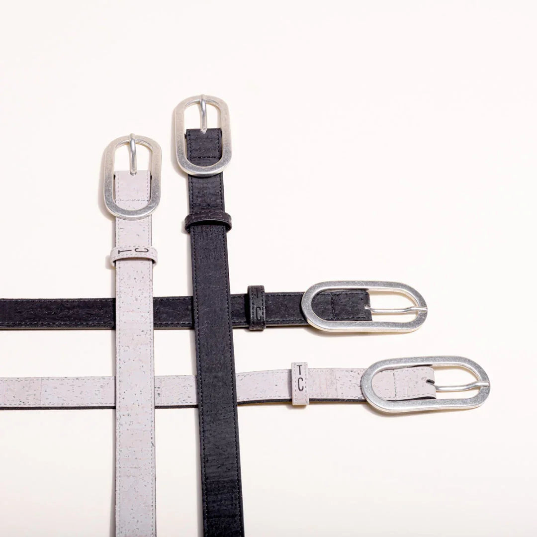 Black and light grey cork belts with silver buckles displayed on a white background at Qu!rk Boutique