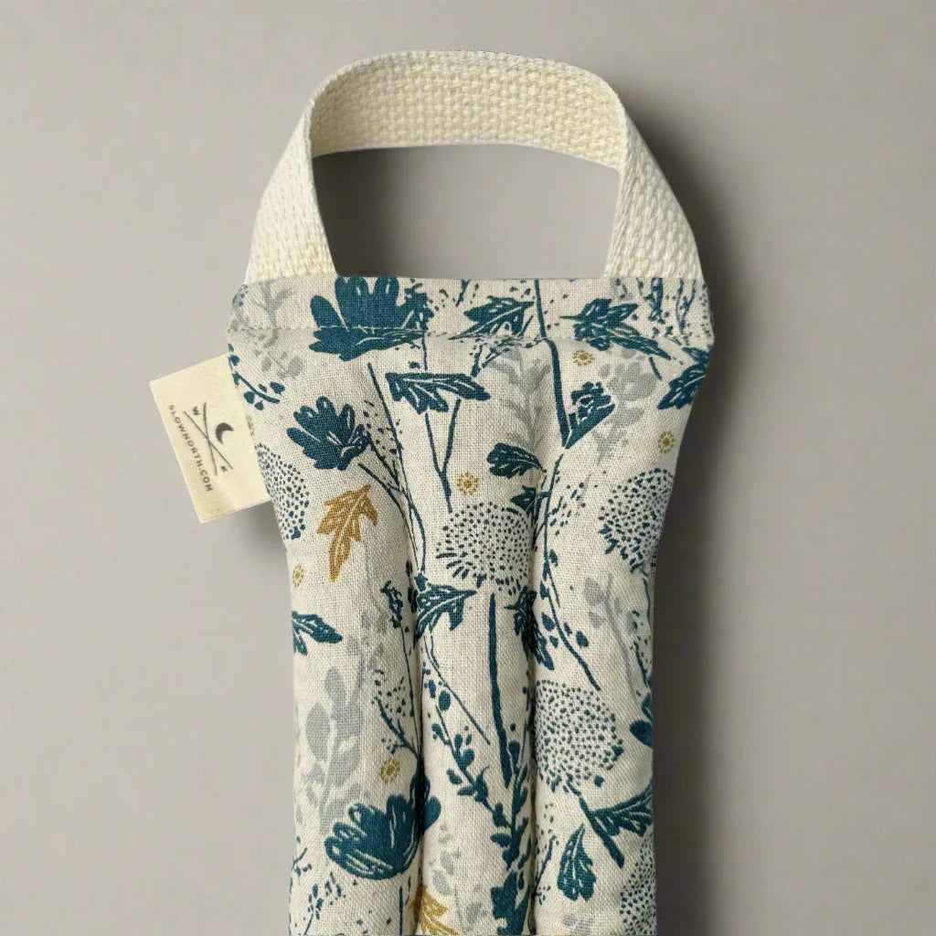 Floral print linen wine bag with sturdy cotton handle against neutral background