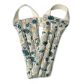 Floral patterned fabric strap with cream handles, featuring teal and mustard botanical prints