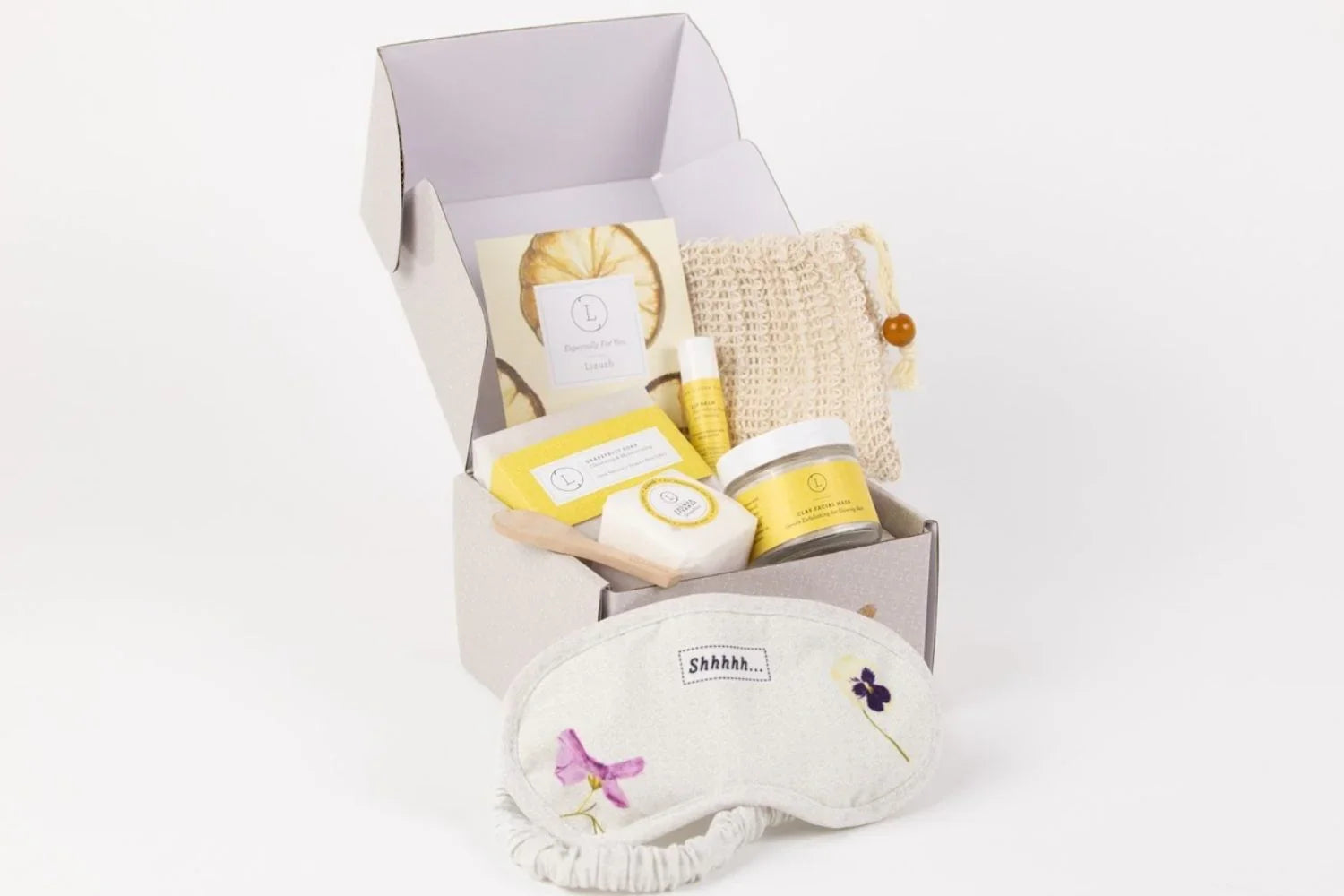Natural citrus skincare gift box with facial mask, soap, balm, scrub, and eye mask