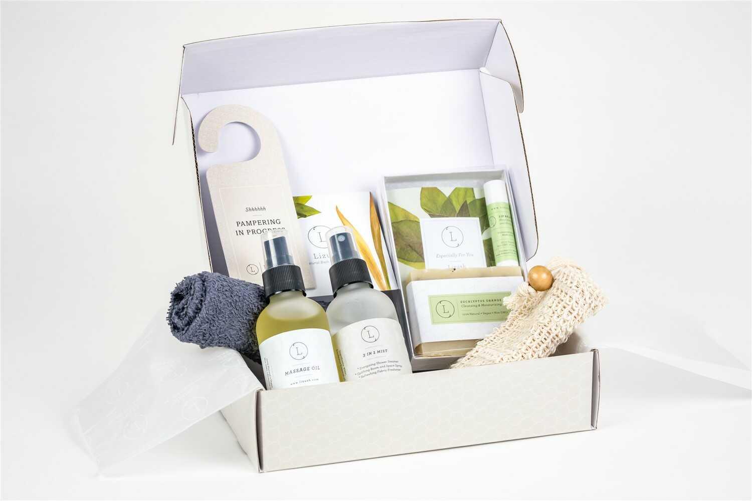 Natural skincare gift box for men with massage oil, 3-in-1 mist, bar soap, lip balm, towel, and pampering sign
