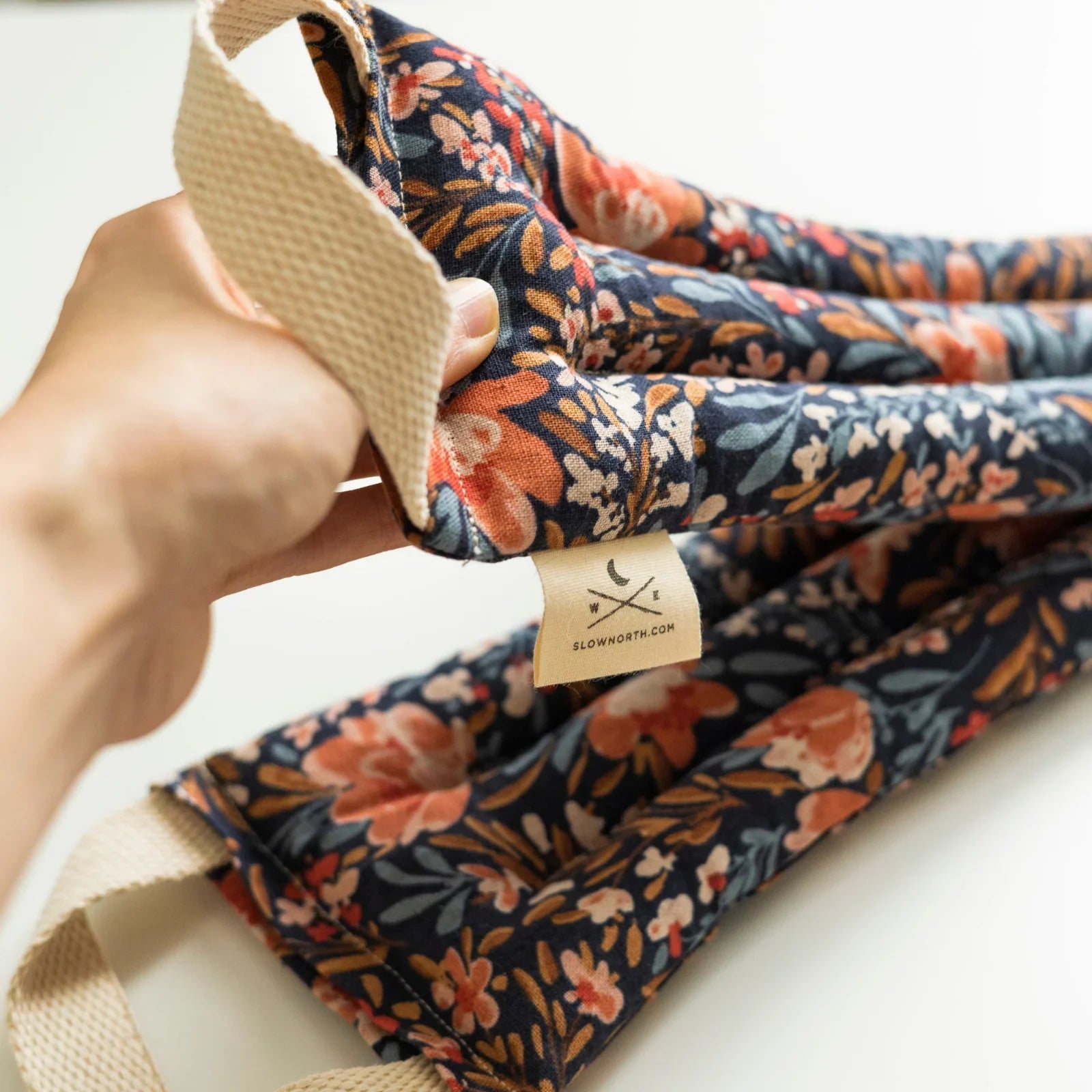 Floral neck wrap with handles, hand-held, artisan-made for Qu!rk Boutique gift shop