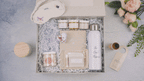 Luxury new mom gift box with water bottle, sleep mask, jar candles, skincare, and cozy essentials