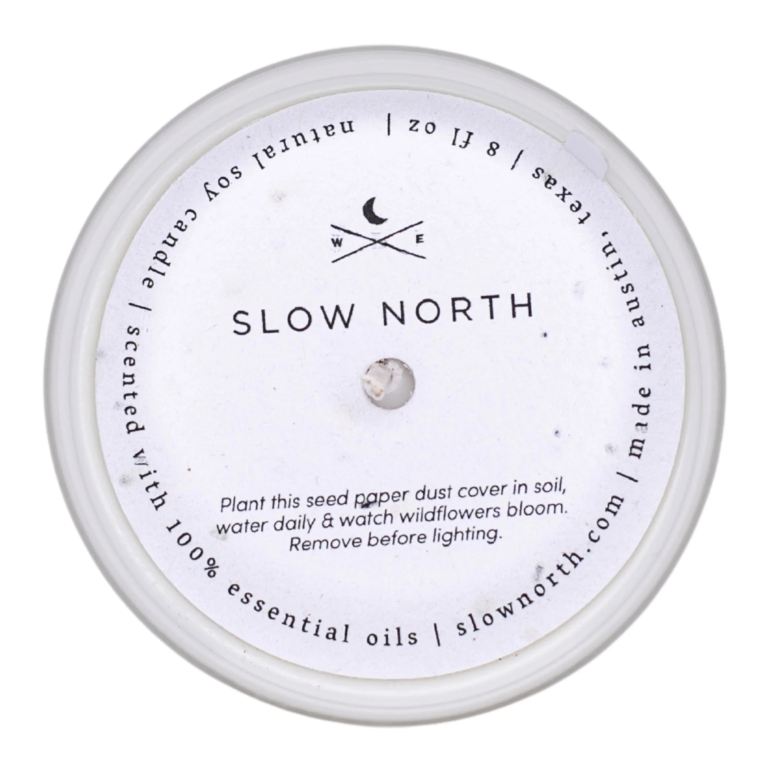Slow North non-toxic soy candle with seed paper dust cover, eco-friendly and essential oil scented.