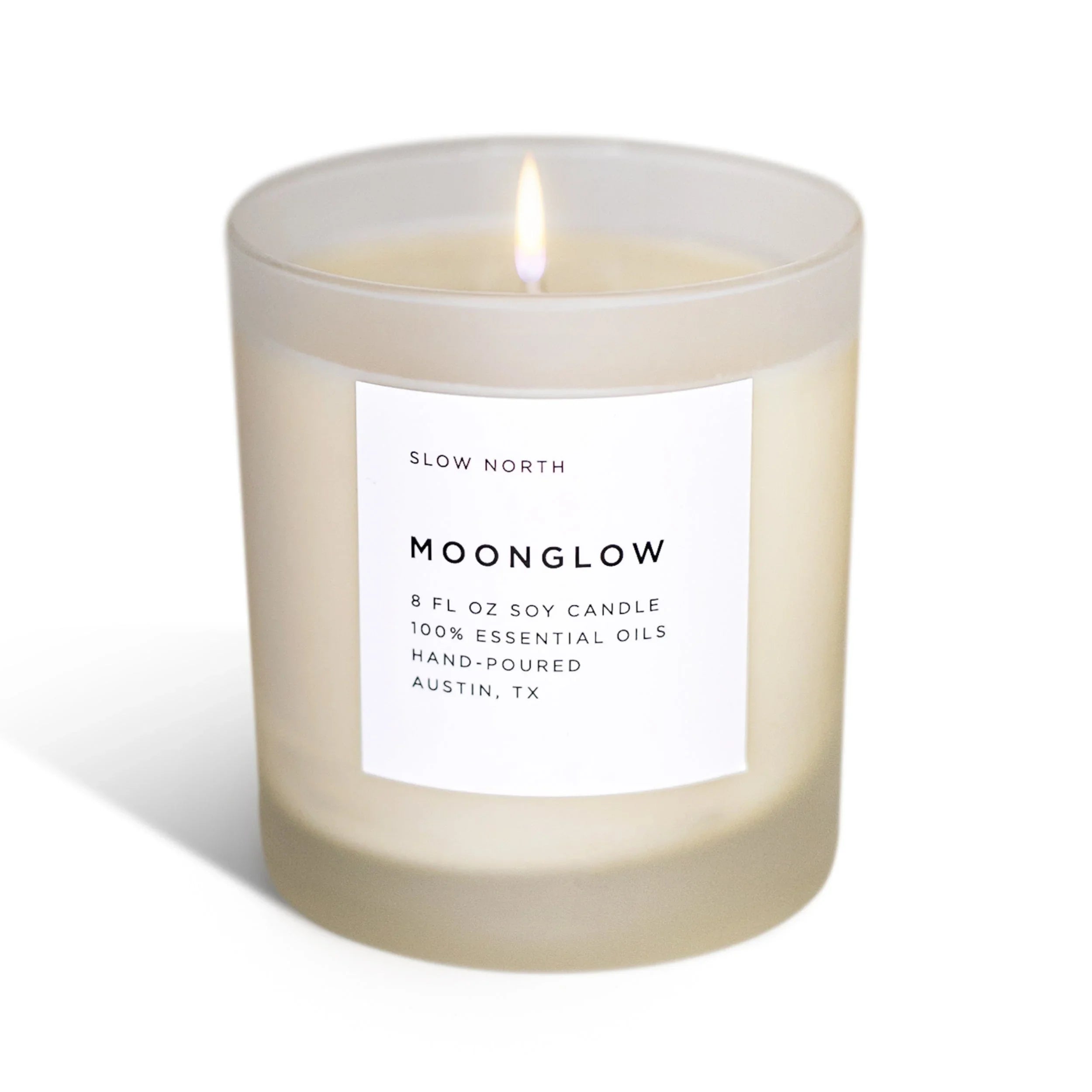 Lit 8 oz Moonglow soy candle with essential oils in frosted glass from Slow North, Austin TX