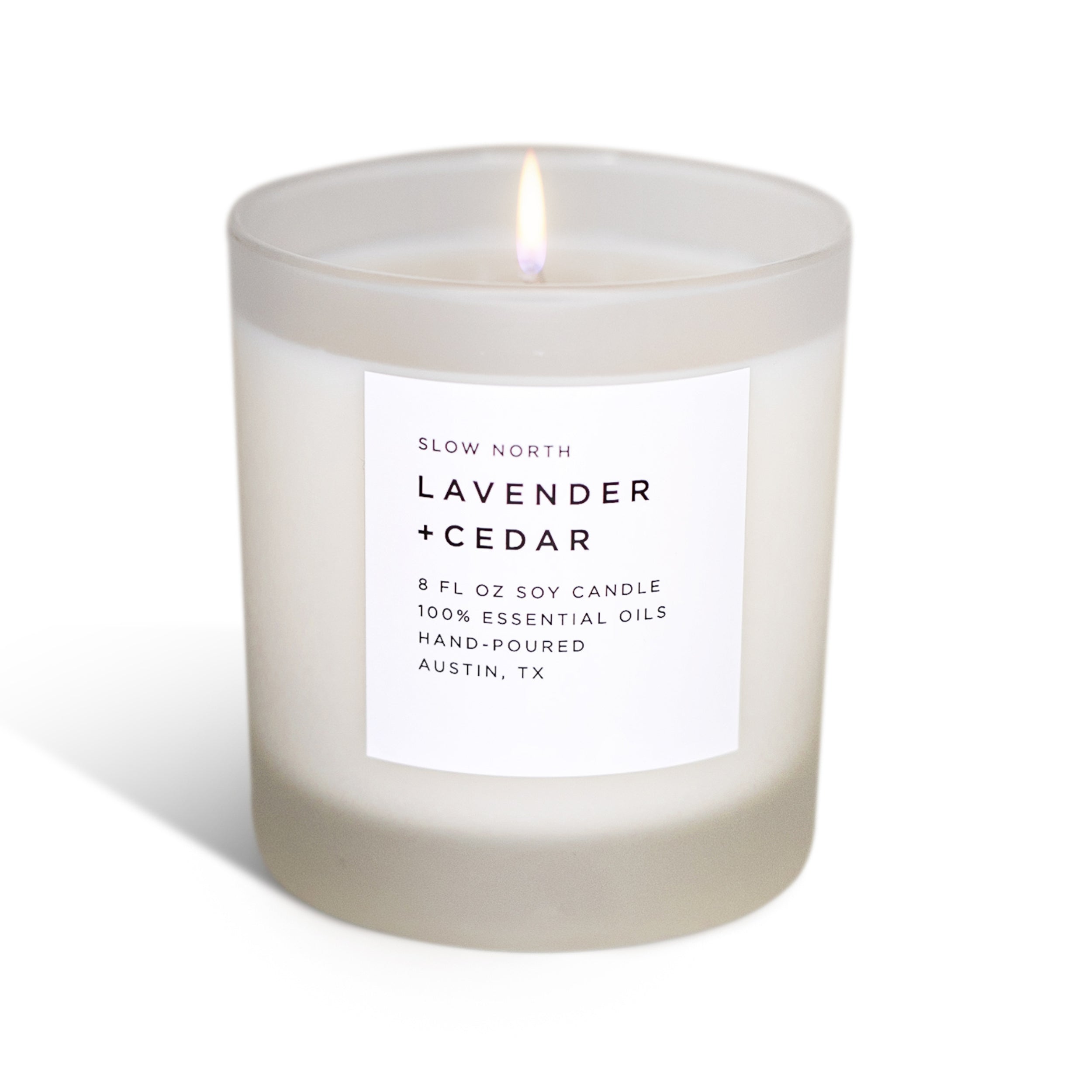 Lit lavender and cedar scented soy candle in frosted glass with minimalist label