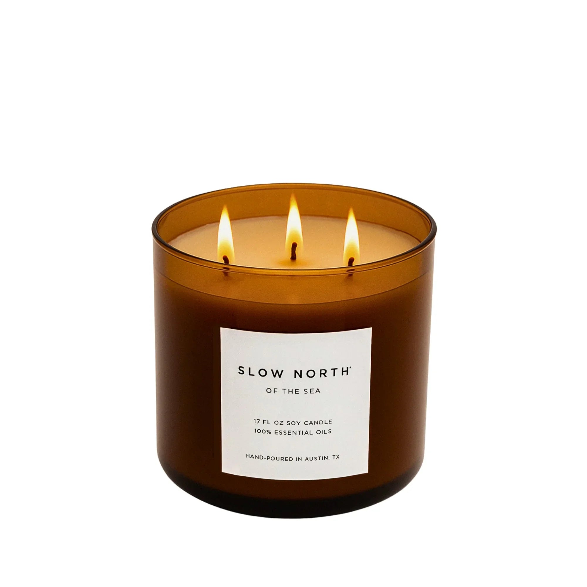 Slow North 3-wick soy candle in amber glass jar, lit, eco-friendly gift at Qu!rk Boutique