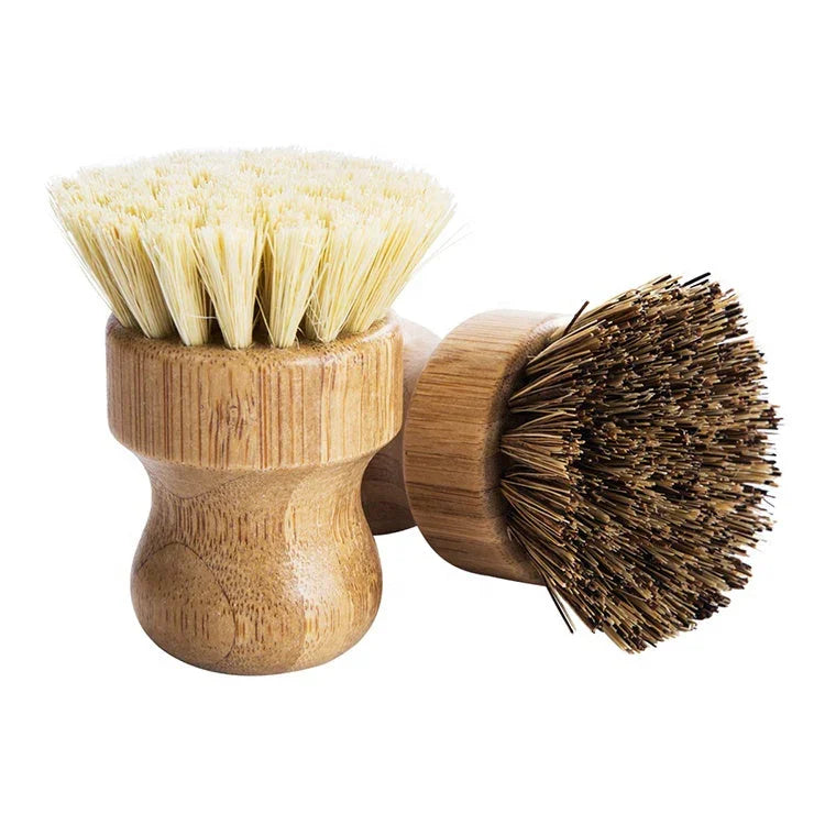 Two wooden scrub brushes with natural bristles, one light and one dark, isolated on white background