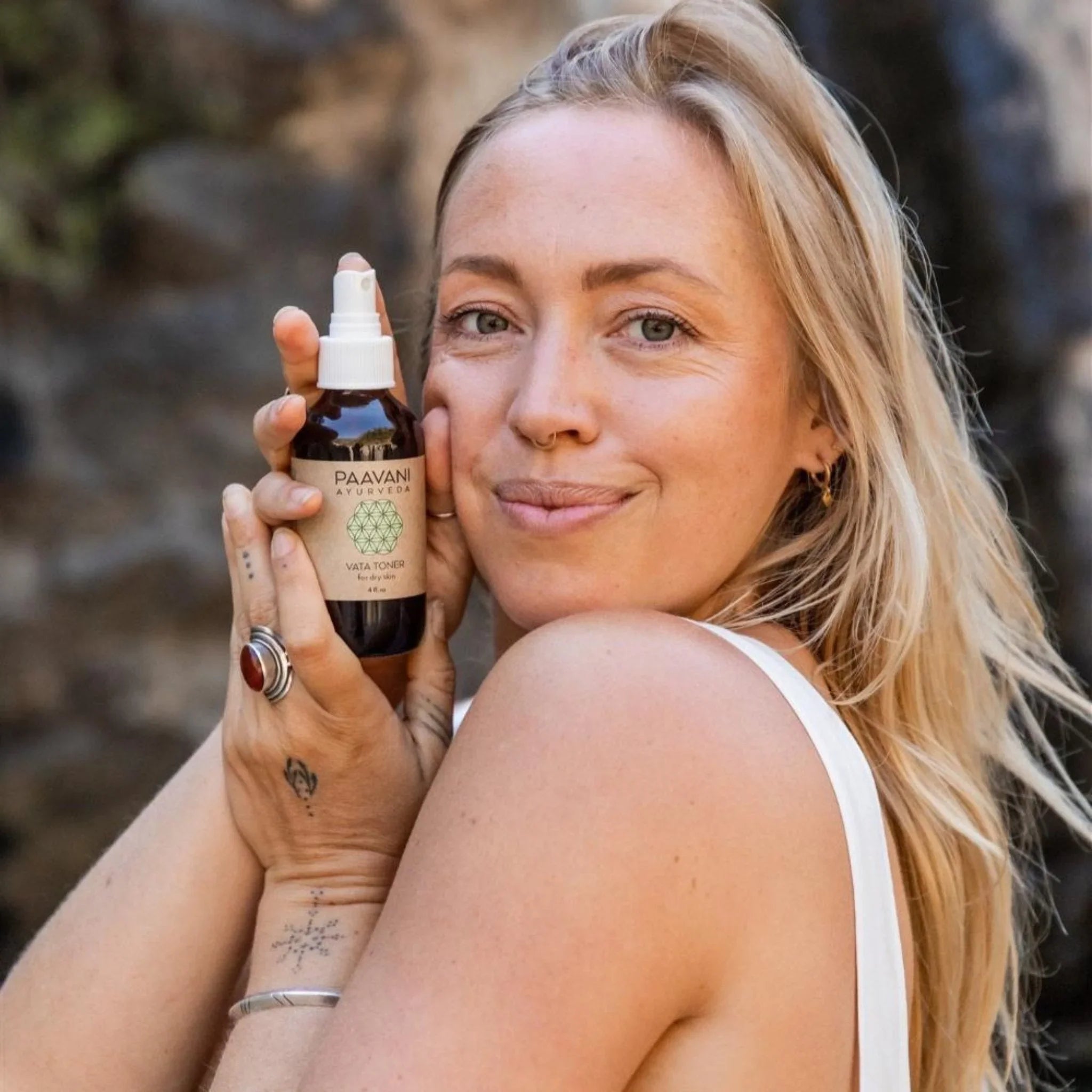 Woman holding Paavani Ayurveda Vata Toner spray, natural skincare product at Qu!rk Boutique