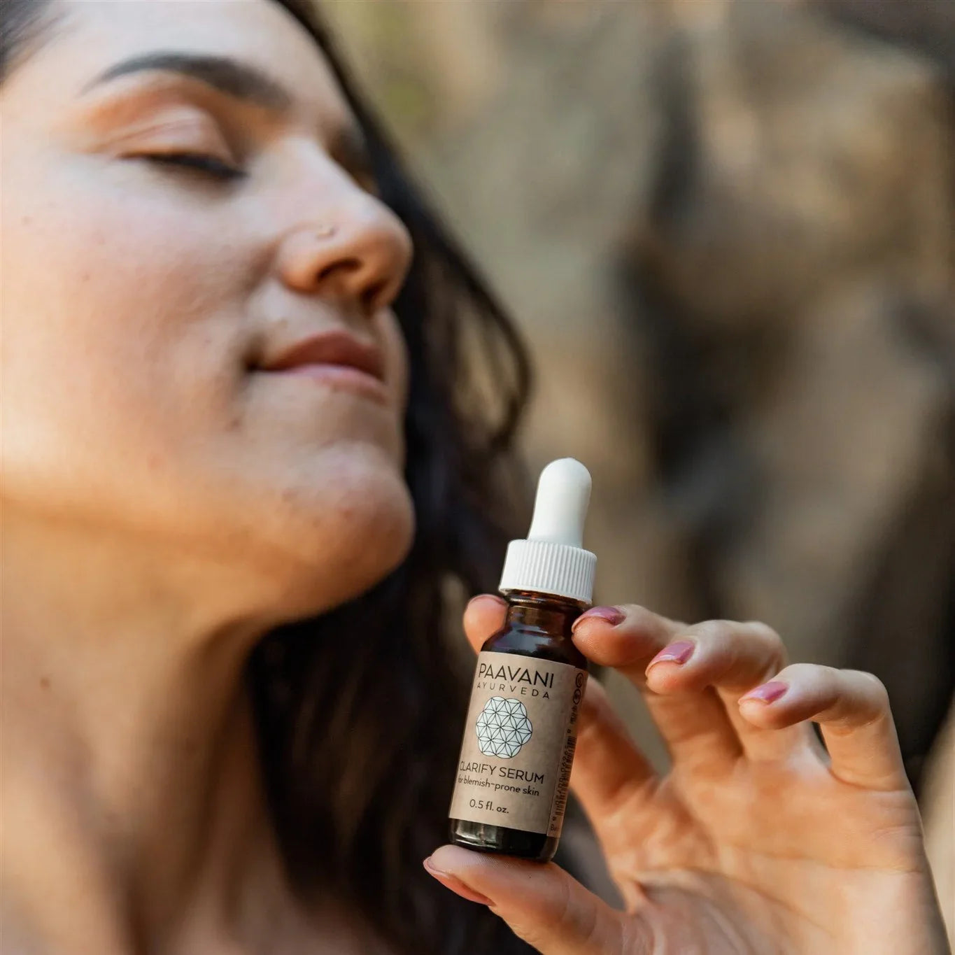 Woman enjoying Paavani Ayurveda Clarify Serum, organic skincare from Qu!rk Boutique