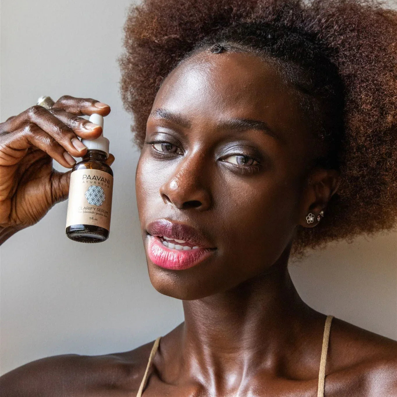 Woman showcasing Paavani Ayurvedic Clarify Serum, eco-friendly beauty at Qu!rk Boutique