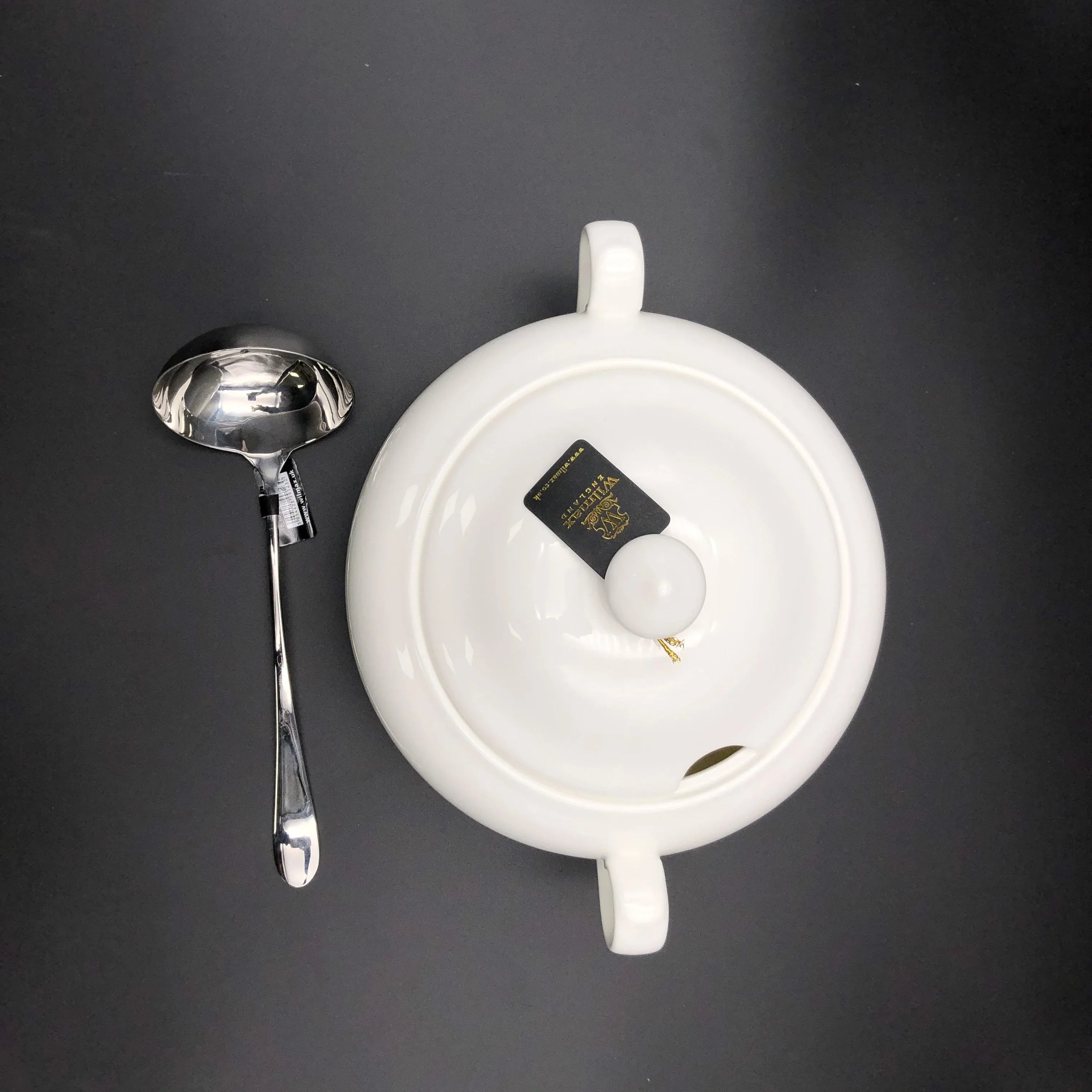 White ceramic soup tureen with lid and ladle on dark background, Qu!rk Boutique giftware