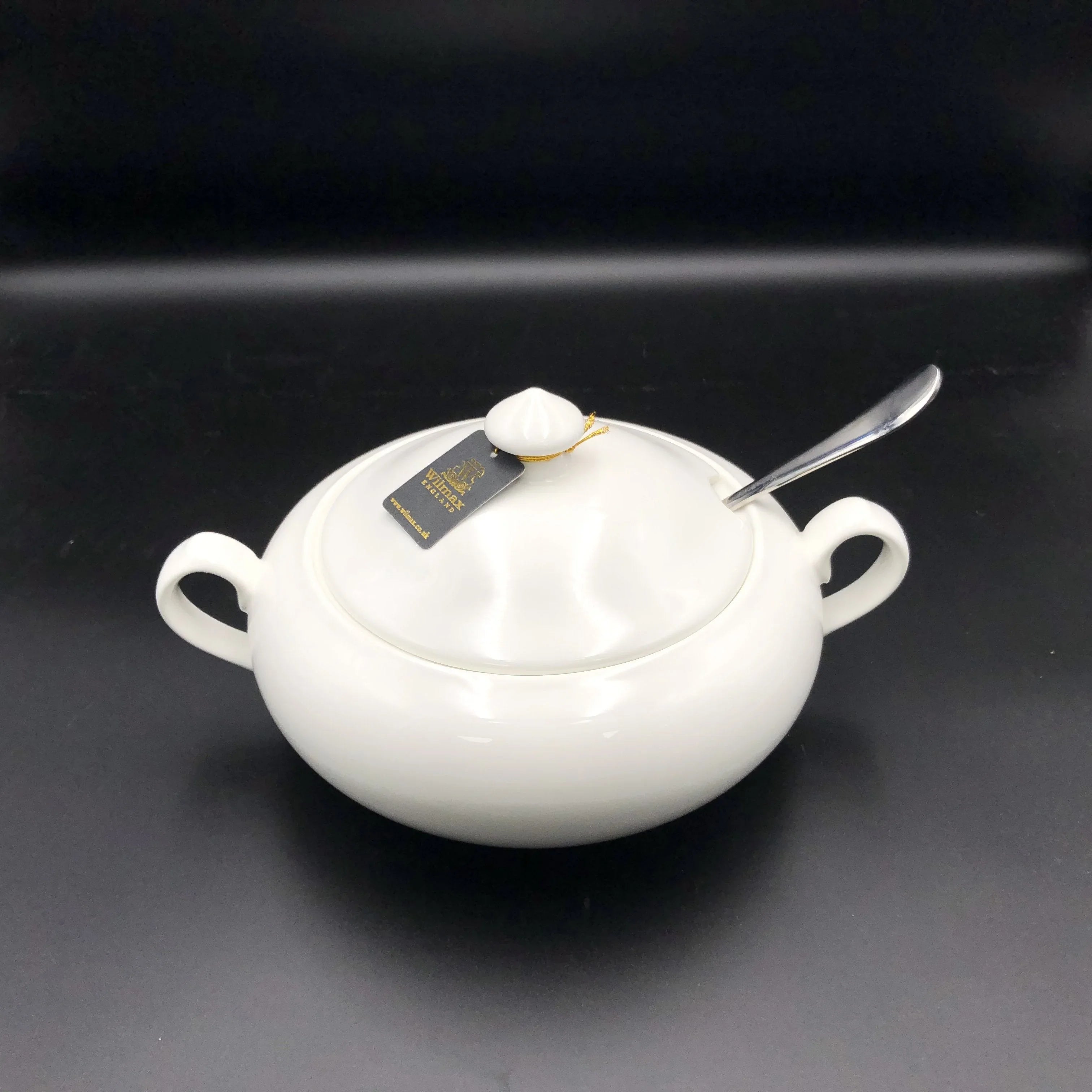 White ceramic soup tureen with lid and spoon, shown on a black background, Qu!rk Boutique