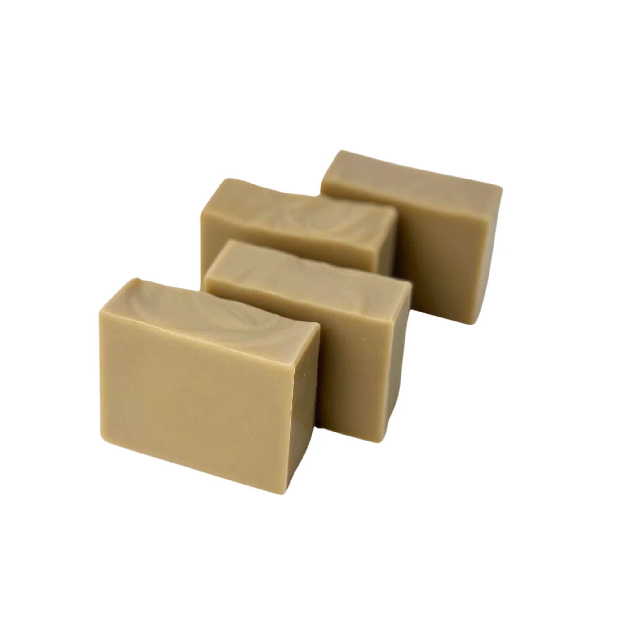 Four beige rectangular soap bars with smooth, swirled tops on a white background