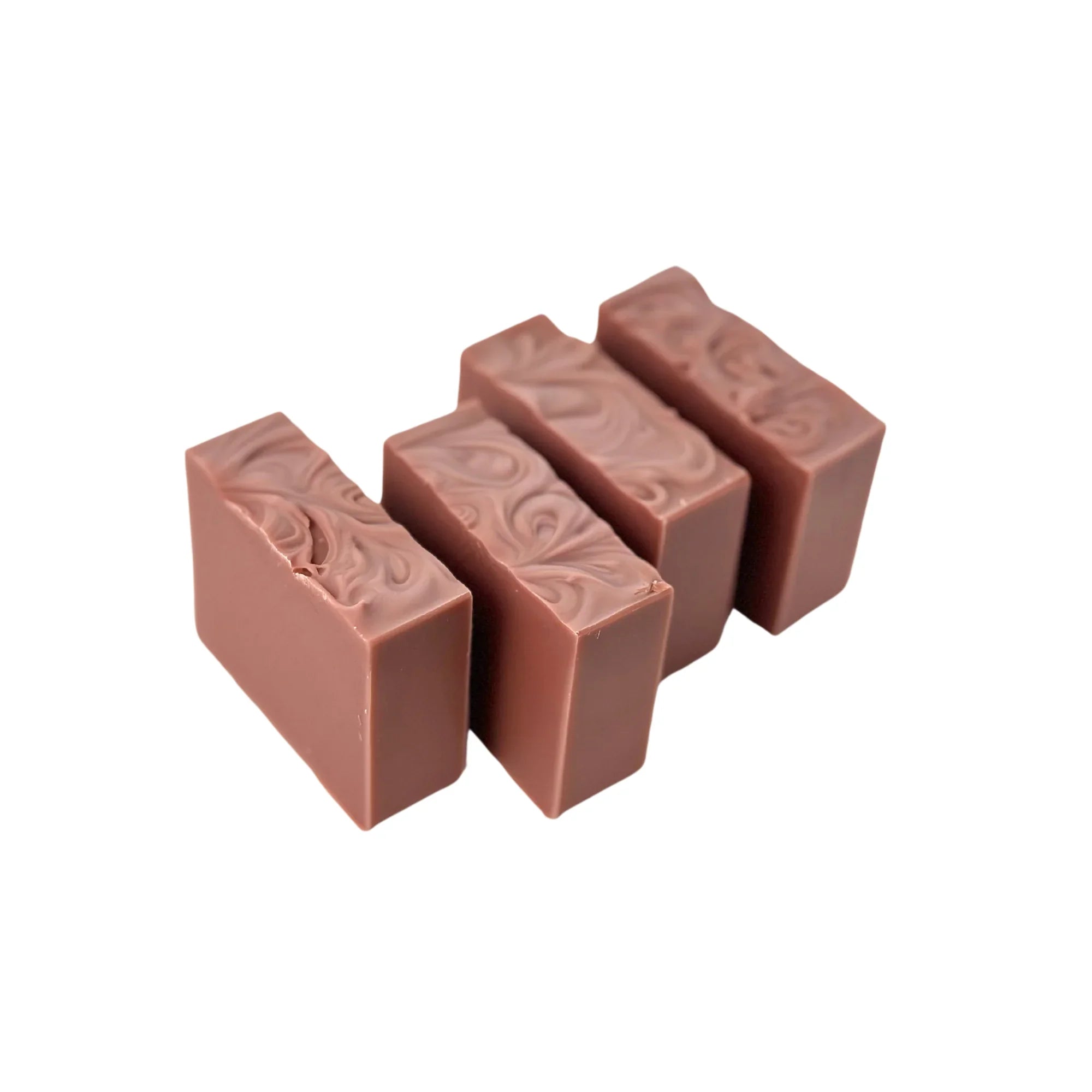 Four handcrafted pink soap bars with decorative swirls on top, isolated on white background