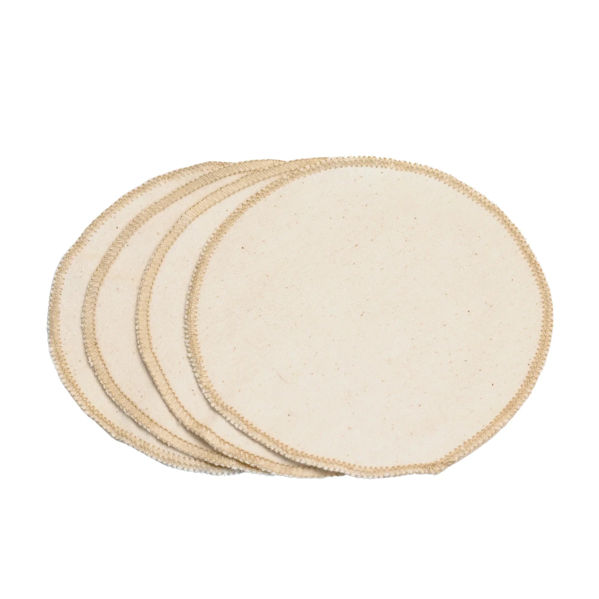 Set of four round beige cotton fabric pads with stitched edges on white background